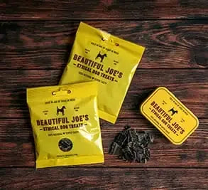 Beautiful Joe's ethical dog treats packaging with dried treats on wooden table